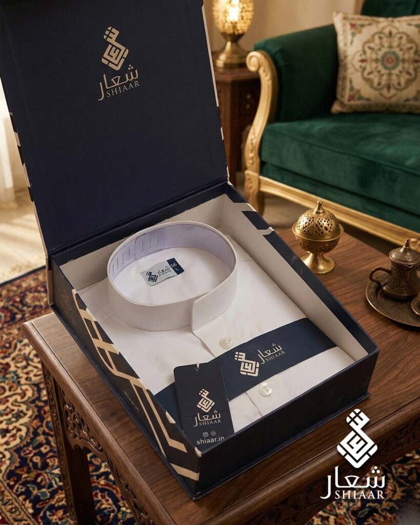 White SHIAAR thobe in branded navy presentation box